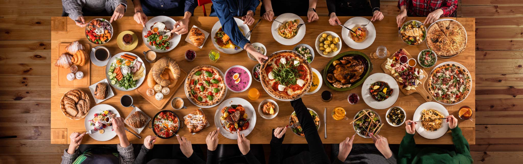 fotografia stołu w restauracji pełnego jedzenia z siedzącymi ludźmi, zdjęcie z góry.